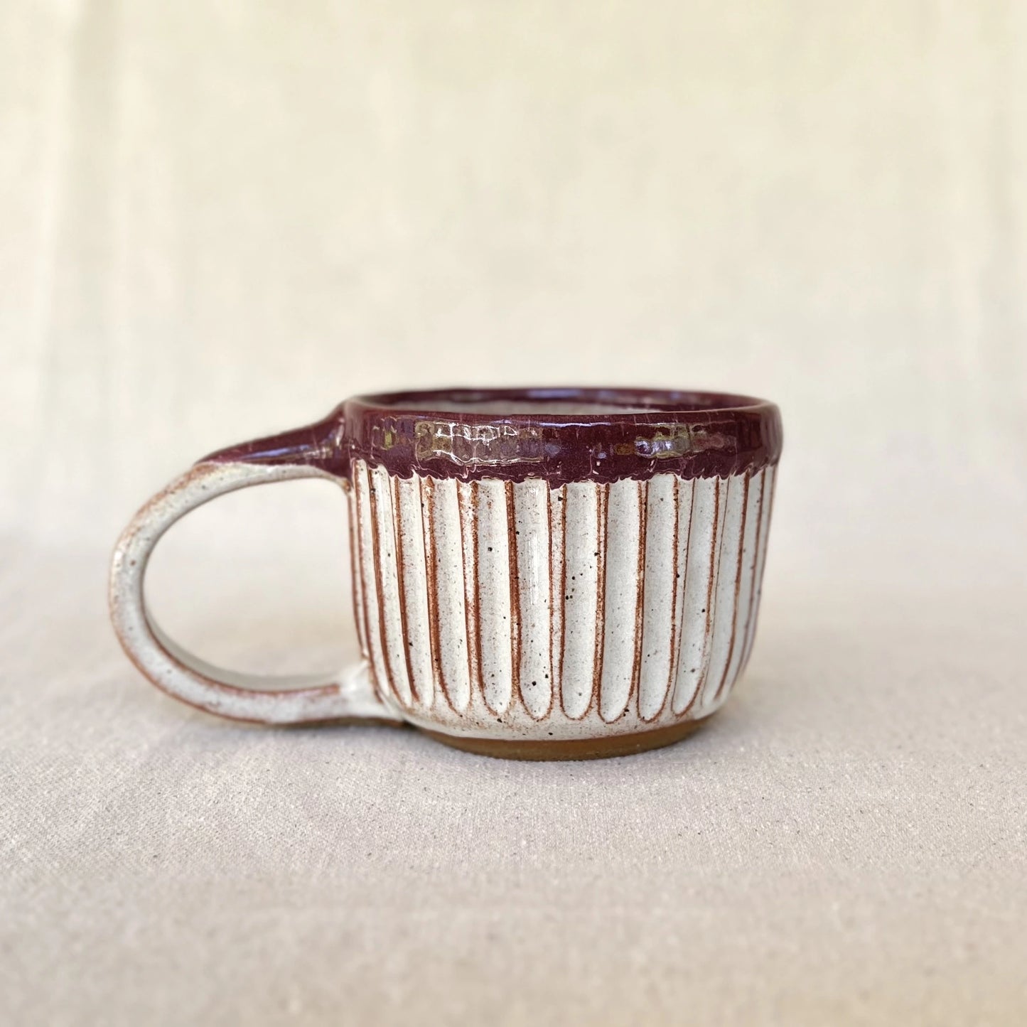 One large hand carved red stoneware latte mug with rustic glaze