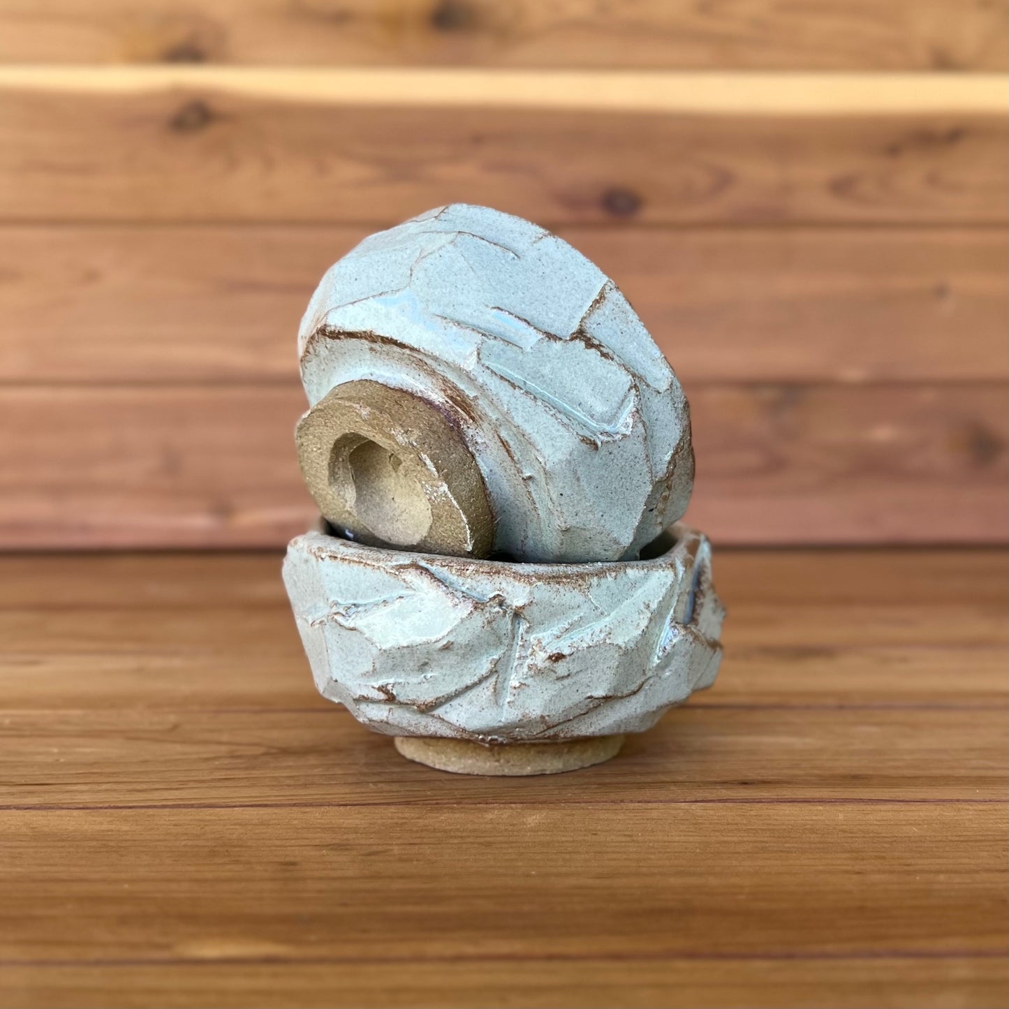two little hand carved Japanese kurinuki pottery cups with a blue gray glaze