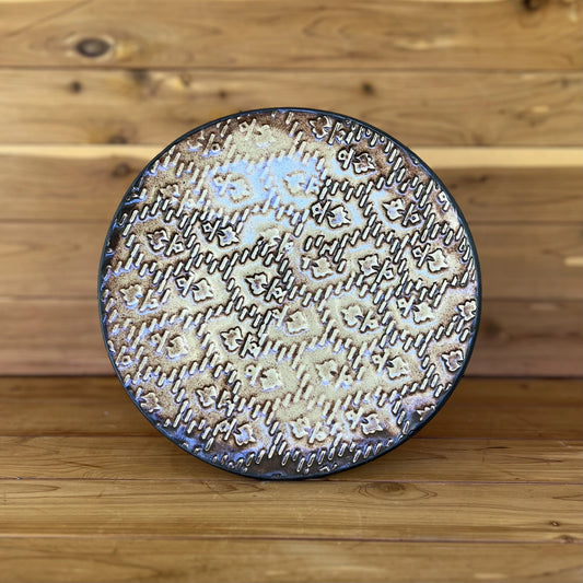 black textured ceramic plate with gold cream glaze