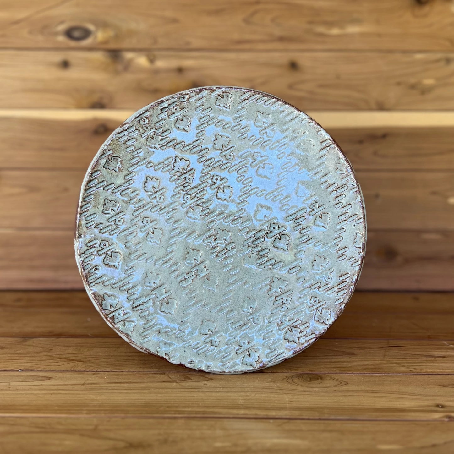 red textured ceramic plate with blue grey glaze