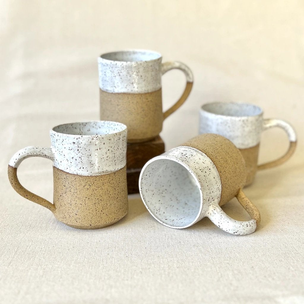 Four speckled ceramic mugs with white glaze