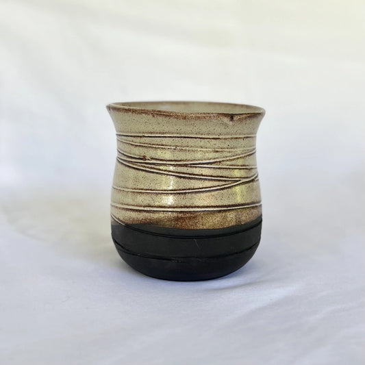 wheel thrown black ceramic wine cup with texture and a gold glaze