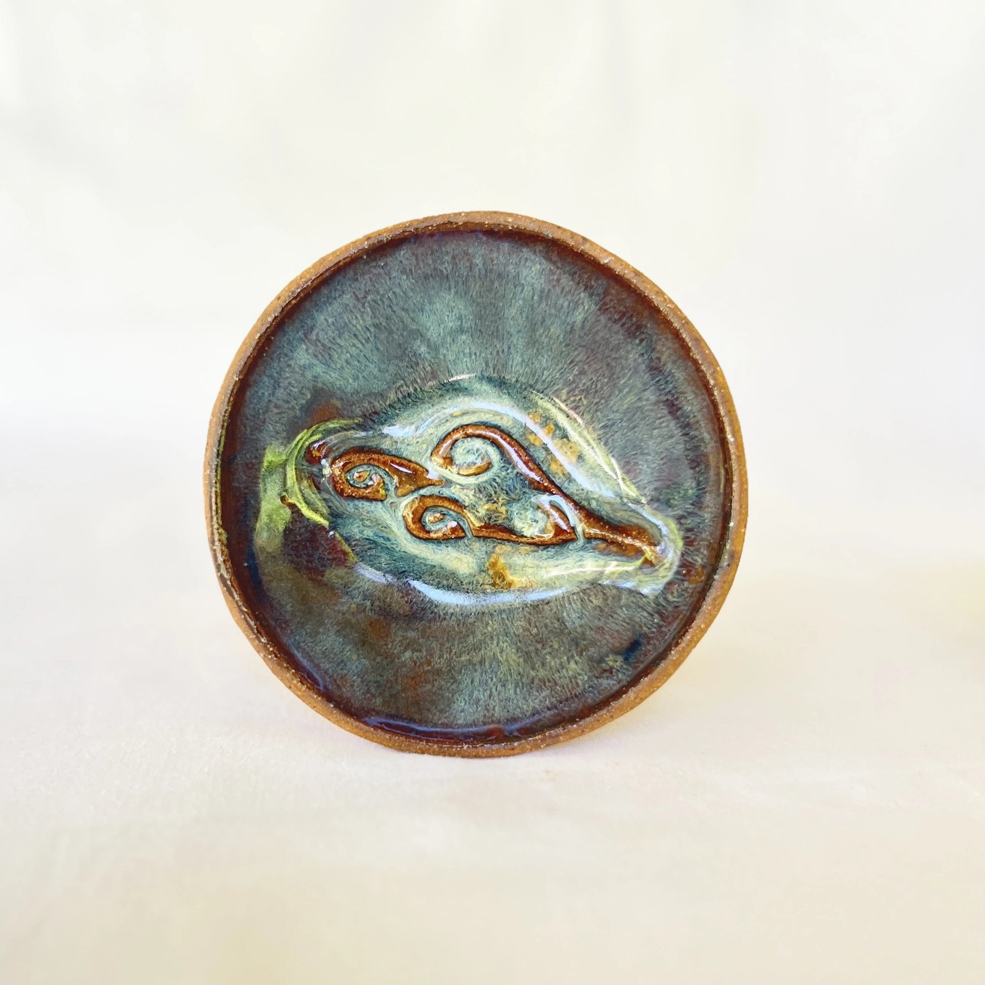 One small ceramic plate with cloud stamp and blue green galaxy glaze