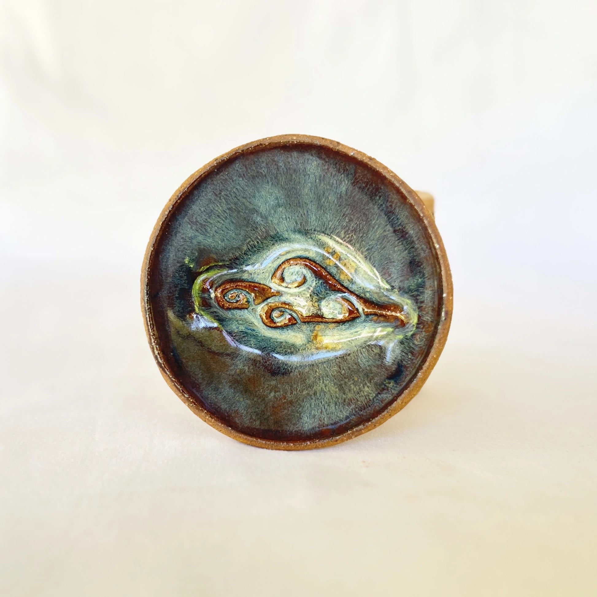 One small ceramic plate with cloud stamp and blue green galaxy glaze
