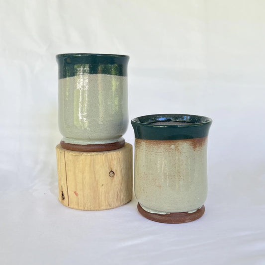 Two large green pottery tumblers in red clay