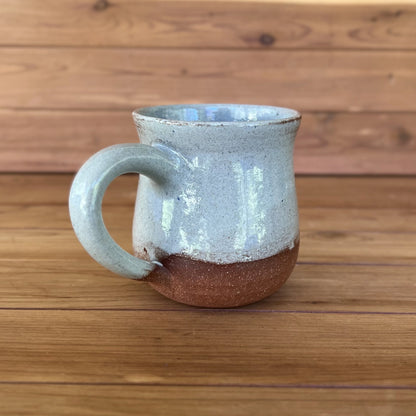 One red stoneware pottery mug glazed in blue