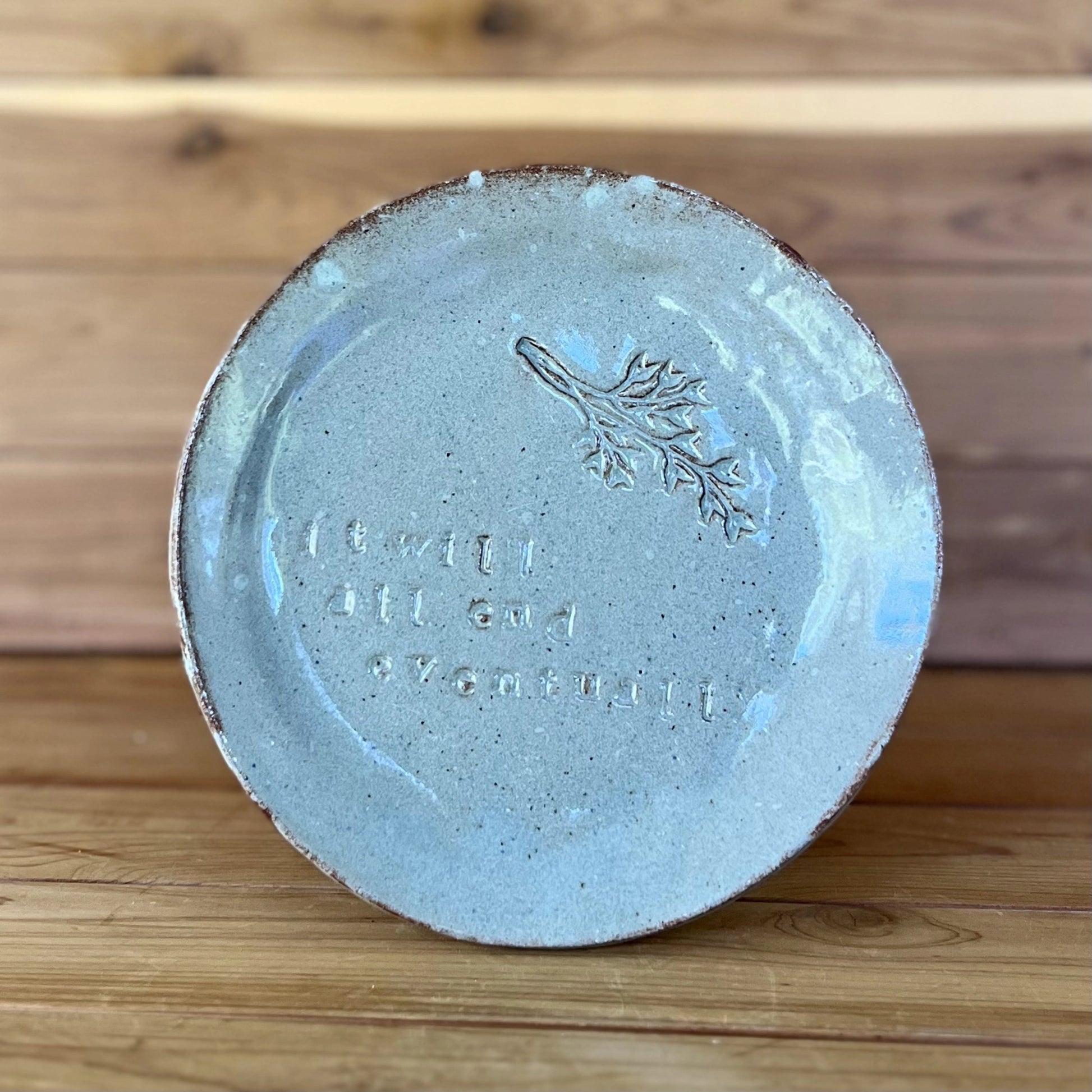 red ceramic plate with saying "it will all end eventually" and botanical stamp