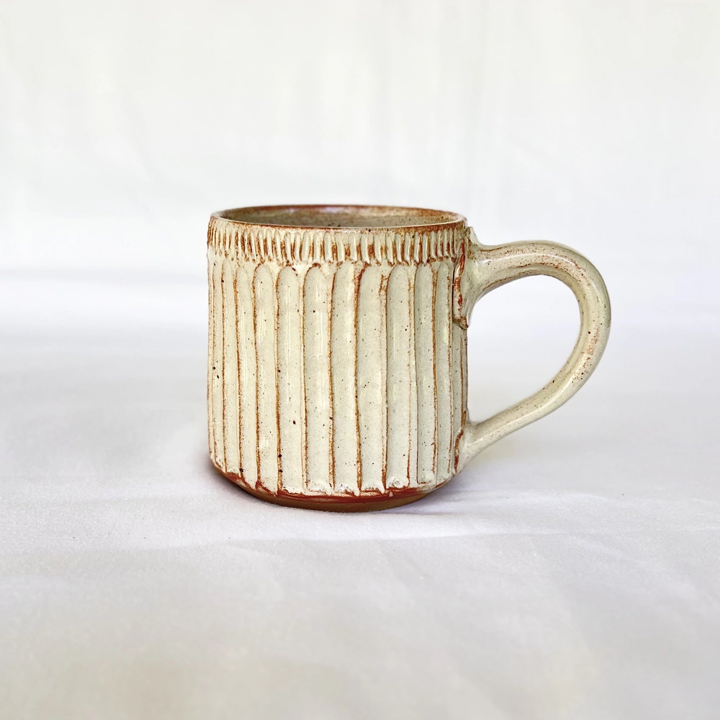 Red and white ceramic coffee mug hand carved