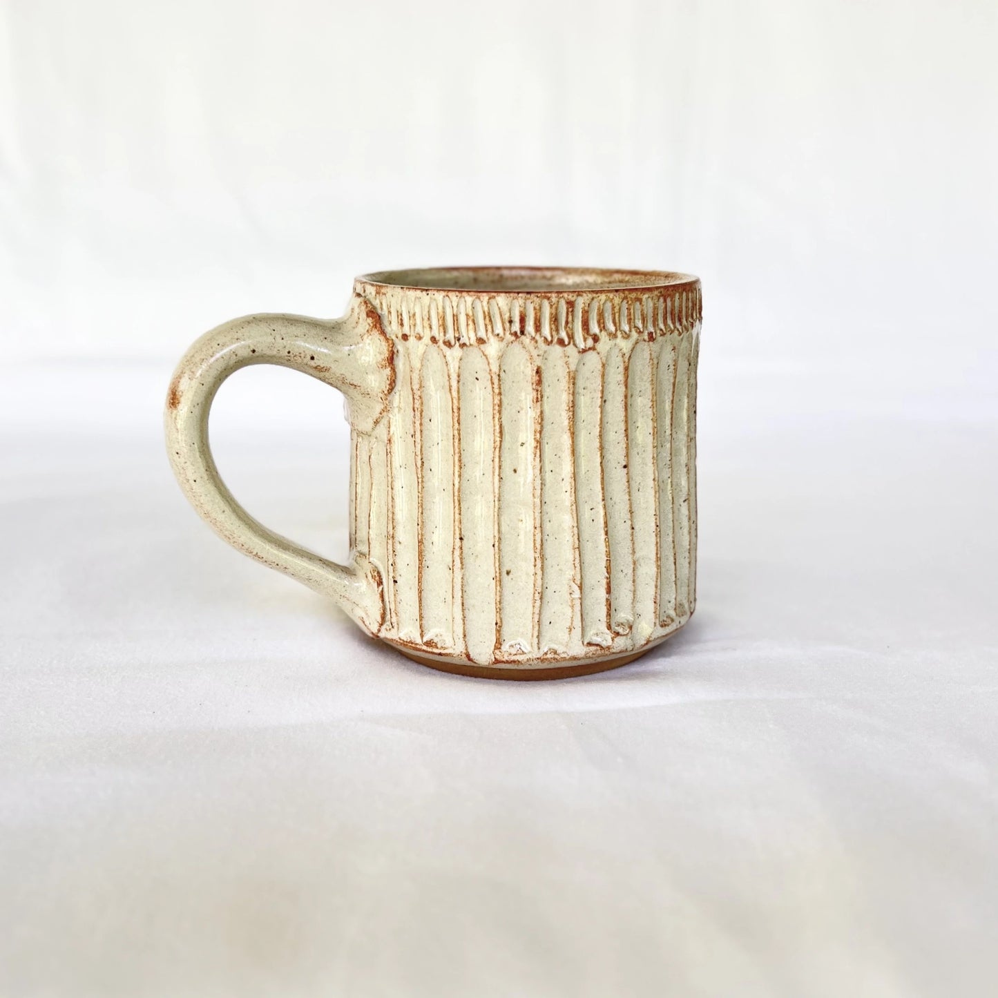 Red and white ceramic coffee mug hand carved