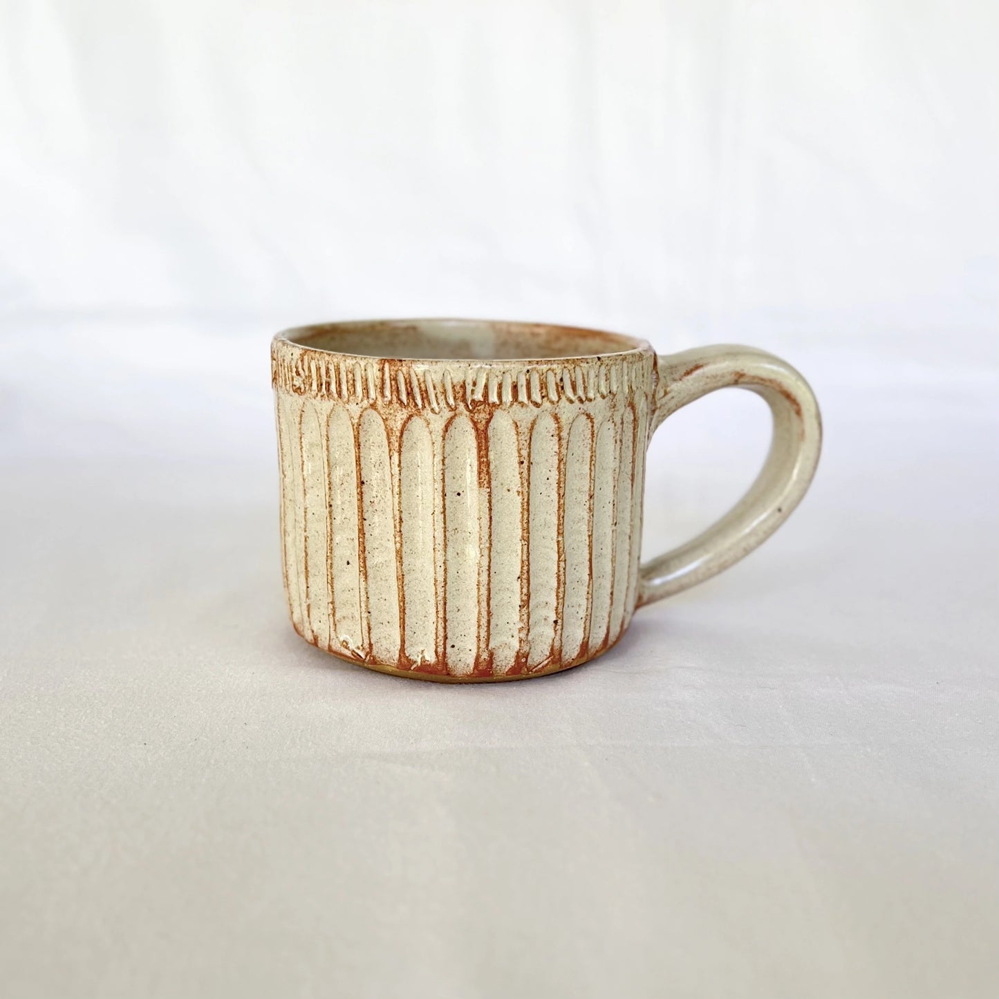 Red and white ceramic coffee mug hand carved